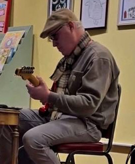 Aaron Russell playing a red guitar